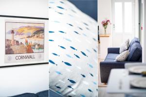 uma sala de estar com um sofá azul e um quadro em Marcella's Retreat em St. Ives