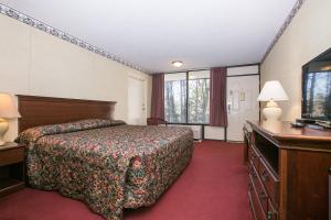 En eller flere senger på et rom på Candlewick Inn and Suites