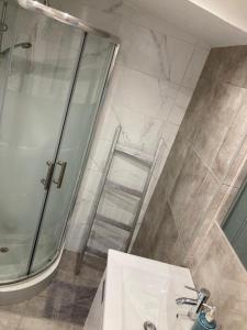 a bathroom with a glass shower and a sink at Yoga Farm in Tavira +66 photos