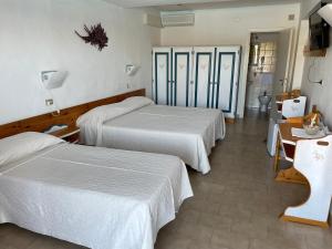 Postel nebo postele na pokoji v ubytování Hotel Olimpia