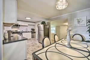 a kitchen with a table and chairs and a refrigerator at Charming Hampton Home Less Than 2 Mi to Buckroe Beach in Hampton