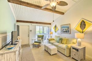 a living room with a couch and a tv at Coastal Condo with Pool Access Less Than 1 Mi to Beach! in Sanibel
