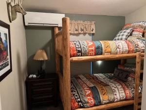 a bedroom with two bunk beds and a lamp at 2 Bedroom Cabin Inside Glacier National Park in West Glacier