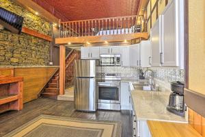 a kitchen with white appliances and a stone wall at Walk to River Unique Studio in Renovated Bar! in Ferryville