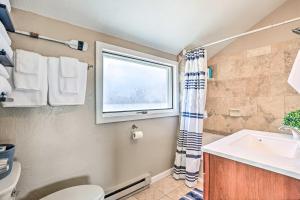 a bathroom with a sink and a window at Walk to Water Grand Lake Home with Hot Tub! in Grand Lake +24 photos