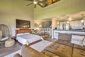 a living room with a couch and a bed at Chic Waikoloa Condo with Lanai and Complex Pools! in Waikoloa