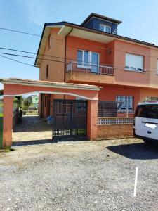 a house with a car parked in front of it at A Pedriña Ribadeo in Ribadeo