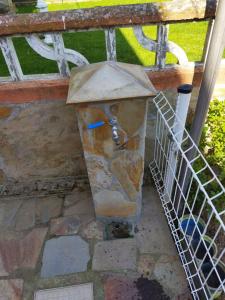 a stone statue of a face on a fence at A Pedriña Ribadeo in Ribadeo +27 photos