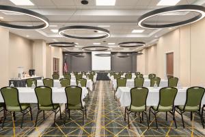 a conference room with rows of tables and chairs at Holiday Inn Florence by IHG in Florence +43 photos