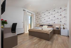 a bedroom with a bed and a wall with butterflies at B&B Villa Oasa 1 in Rovinj +86 photos