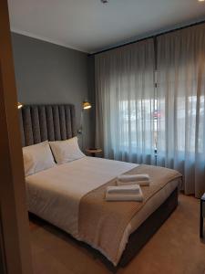 a bedroom with a large bed with two towels on it at River Eyes Suites in Vila Nova de Gaia