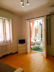 a living room with a door open to a patio at Classic Monterossino Apartment in Old Town in Monterosso al Mare