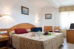 a bedroom with a bed with a box on it at Hotel Cabo Festiñanza in Sanxenxo