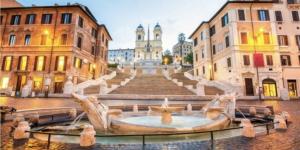 a fountain in the middle of a city with buildings at Casa Casella, delizioso bilocale a due passi dal mare in Lido di Ostia