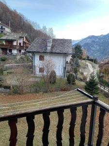 a house on a hill next to a fence at Petit-Antey 38 in Antey-Saint-André