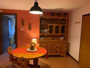 a dining room with a table and a cabinet at Petit-Antey 38 in Antey-Saint-André