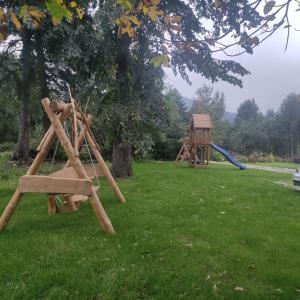 a park with a swing set and a playground at Domek pod Karpaczem in Miłków +4 photos