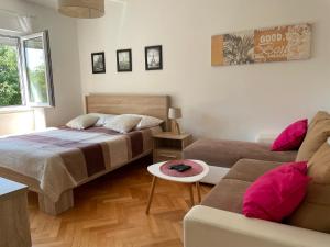 a bedroom with a bed and a couch at Apartment Beauty in Pula