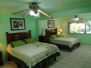 A bed or beds in a room at Freedom Shores "La Gringa" Hotel - Universally Designed