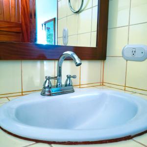 a white sink in a bathroom with a mirror at San Bosco Inn in Fortuna