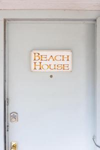 a sign on the door of a beach house at Beach House in Alpine in Alpine
