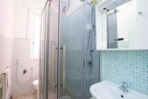 a bathroom with a shower and a sink and a toilet at Classic Monterossino Apartment in Old Town in Monterosso al Mare +2 photos