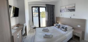 a bedroom with a large bed with a large window at Sun&Sea in Jastarnia +162 photos