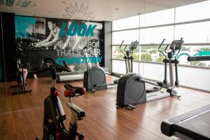 a gym with several treadmills and elliptical machines at Mia City Villahermosa in Villahermosa
