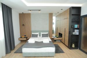 a bedroom with a large bed in a room at Bonanza Apartments in Niš +33 photos