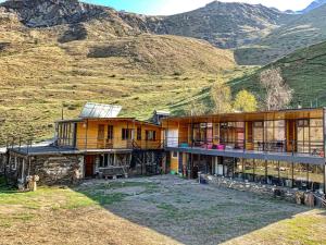 a large house with mountains in the background at Ardoti Guest House in Ardoti