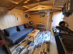 a living room with a blue couch and a table at Little house in Vacarisas