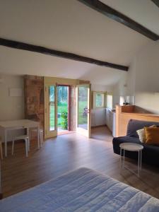 a living room with a bed and a table at Pazo Cibrán in San Xulián de Sales