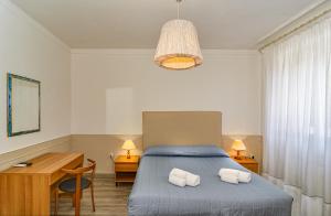 Postel nebo postele na pokoji v ubytování Hotel Ambra