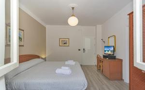Postel nebo postele na pokoji v ubytování Hotel Ambra