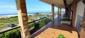 a balcony with a view of the beach at Apartamento Tomela in Noja +18 photos
