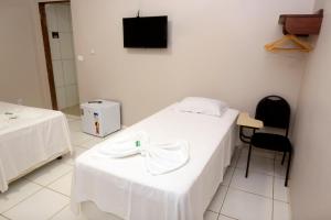 a hospital room with two beds and a television at HOTEL CAPITAL PALMAS in Palmas