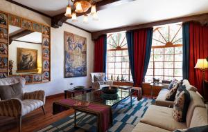 a living room filled with furniture and decor at Palacio Manco Capac by Ananay Hotels in Cusco
