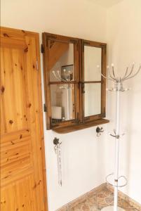 a bathroom with a medicine cabinet and a toilet at Ferienhaus Leo in Boblitz +14 photos