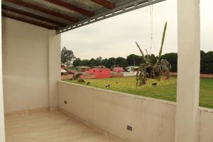 a balcony with a view of a field of cows at HOTEL 80 REAL in Tenjo