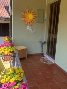 una habitación con flores y una señal de sol en la pared en Sole, en Gattinara