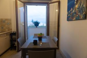 a dining room table with a potted plant on it at MrBrown - Cinzia Resort Beach in Mazara del Vallo