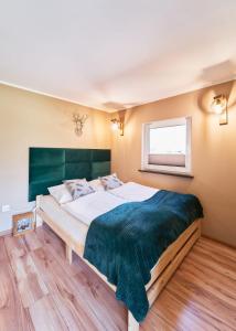 Säng eller sängar i ett rum på Marel-Apartments Domek Duna Lux Polanica Zdrój