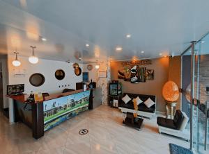 a living room with a couch and a tv at HOTEL 80 REAL in Tenjo