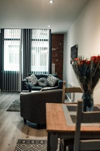 a living room with a couch and a table at Bv Apartments Conditioning House Bradford in Bradford