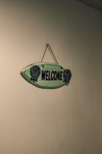 a sign that says welcome hanging on a wall at Bv Apartments Conditioning House Bradford in Bradford
