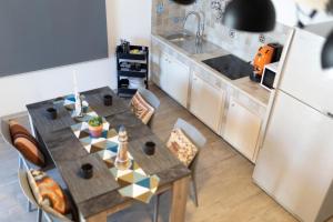 a kitchen with a table with chairs and a sink at MrBrown - Cinzia Resort Beach in Mazara del Vallo