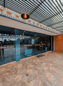 an empty building with glass walls and blue chairs at HOTEL 80 REAL in Tenjo
