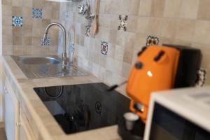 a kitchen with a sink and a counter with aounter at MrBrown - Cinzia Resort Beach in Mazara del Vallo