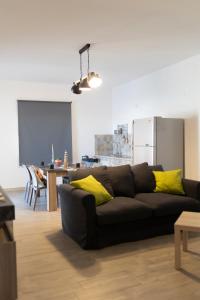 a living room with a black couch and a table at MrBrown - Cinzia Resort Beach in Mazara del Vallo