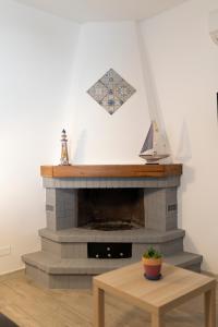 a living room with a brick fireplace with a wooden table at MrBrown - Cinzia Resort Beach in Mazara del Vallo
